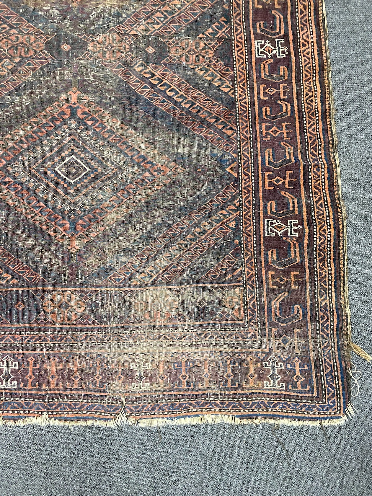 A Belouch red ground rug, 226 x 122cm